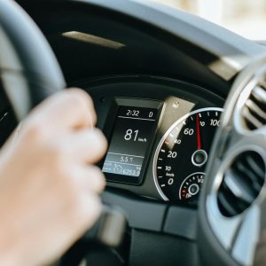 person driving car in sunny day