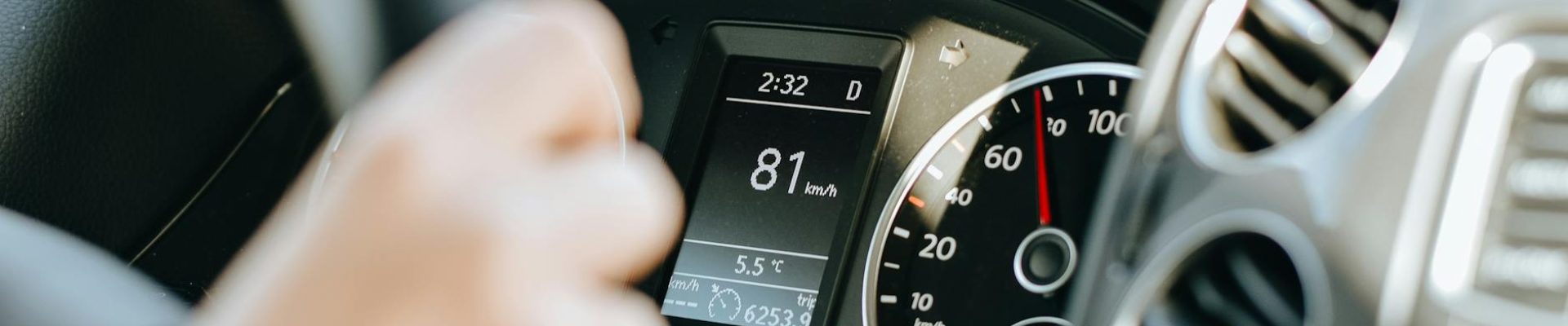 person driving car in sunny day